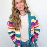 Woman wearing a colorful striped cardigan against a white background