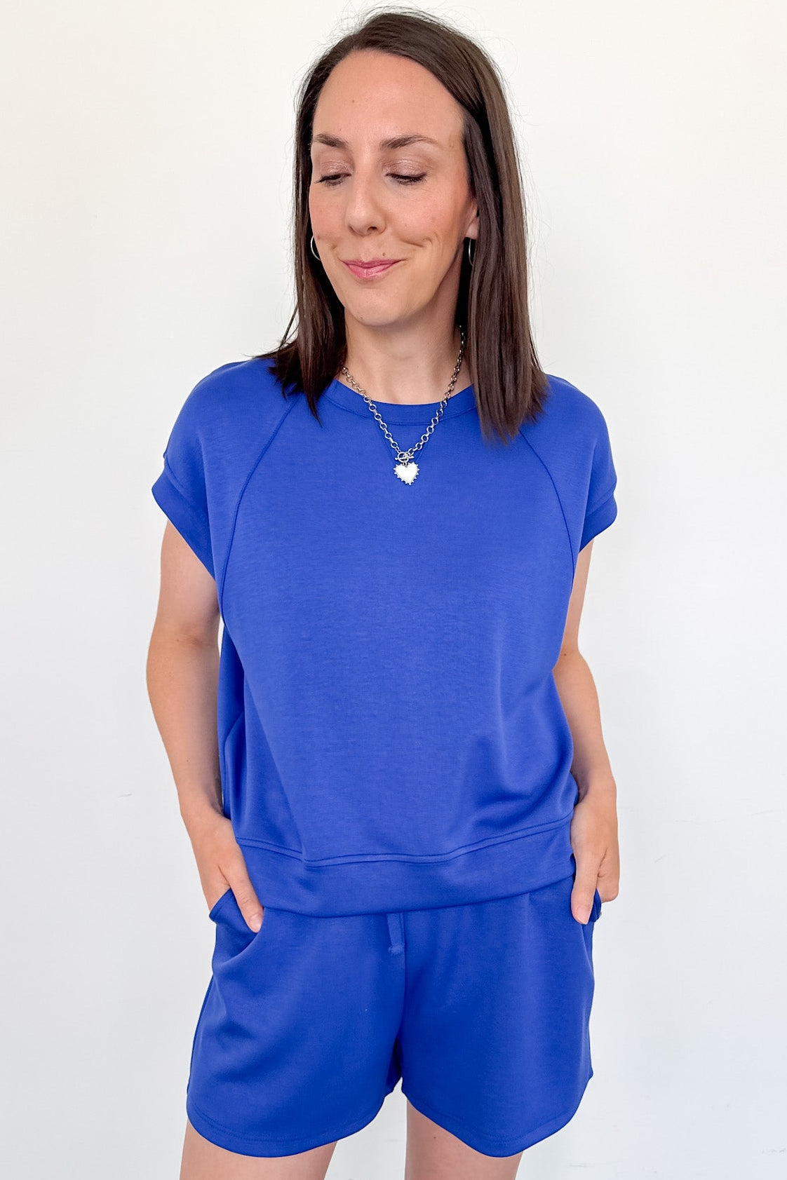 Woman wearing a blue outfit against a white background