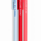Three pens in light blue, red, and pink with motivational text on a white background