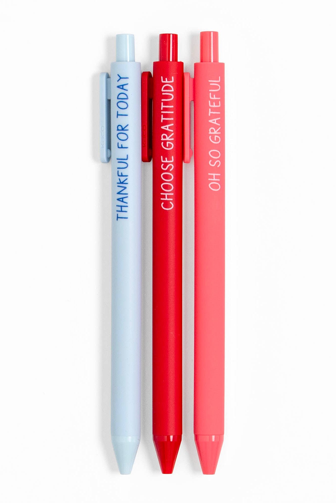 Three pens in light blue, red, and pink with motivational text on a white background