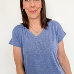 Woman wearing a blue t-shirt against a white background