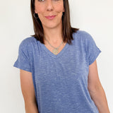 Woman wearing a blue t-shirt against a white background