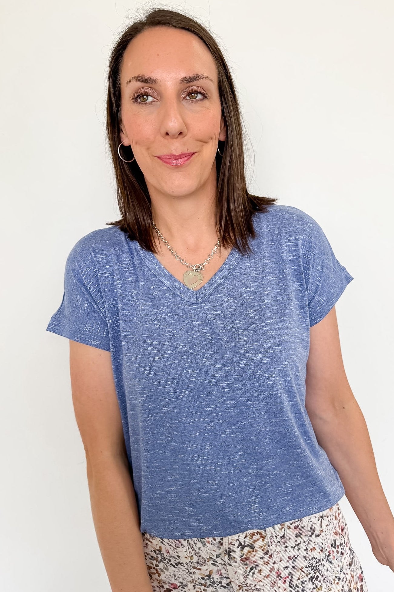 Woman wearing a blue t-shirt against a white background