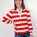Woman wearing a red and white striped shirt against a white background