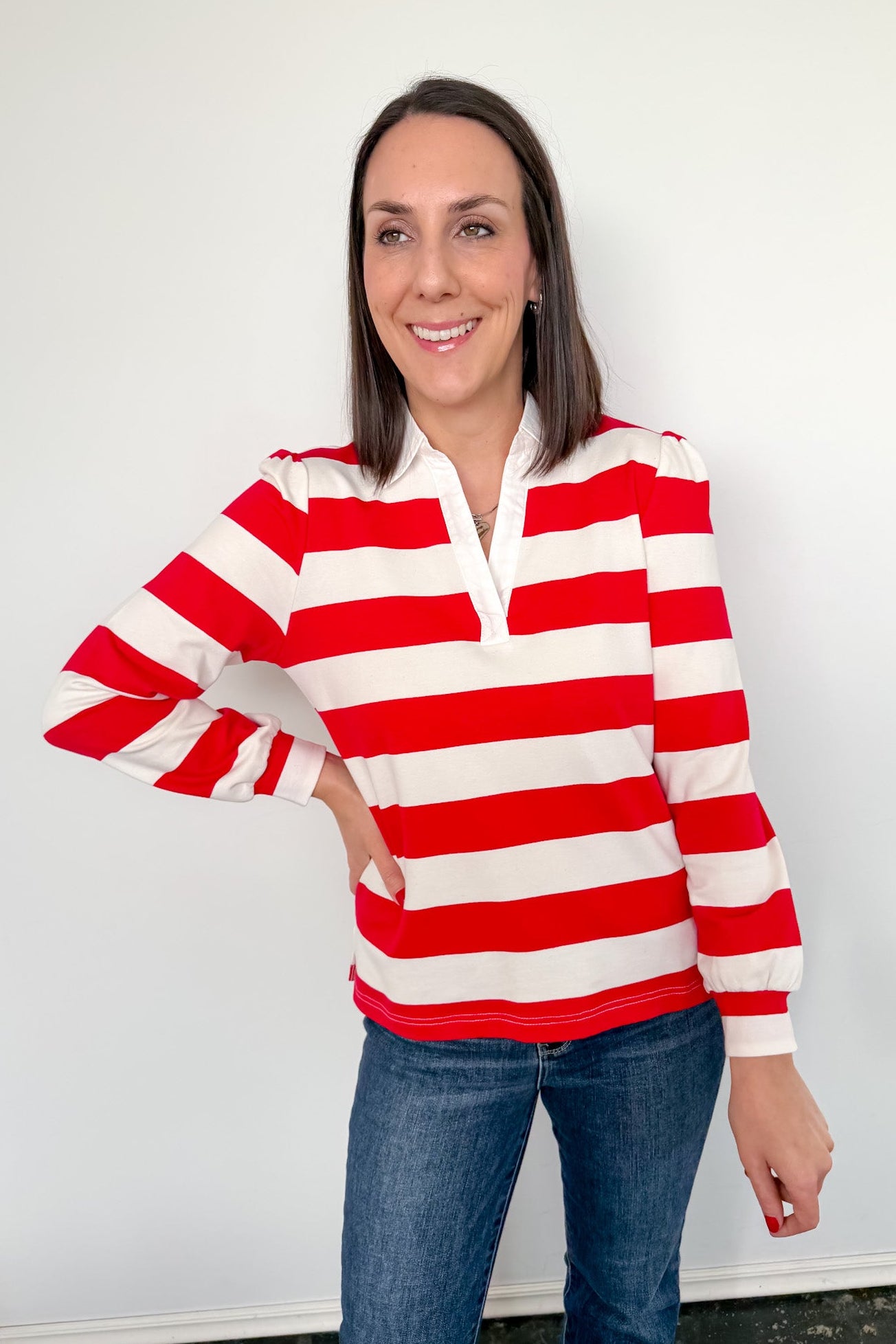 Woman wearing a red and white striped shirt against a white background