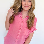Woman wearing a pink shirt against a white background