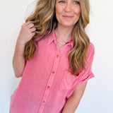 Woman wearing a pink shirt against a white background