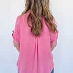 Person wearing a pink shirt from behind on a white background