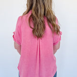 Person wearing a pink shirt from behind on a white background