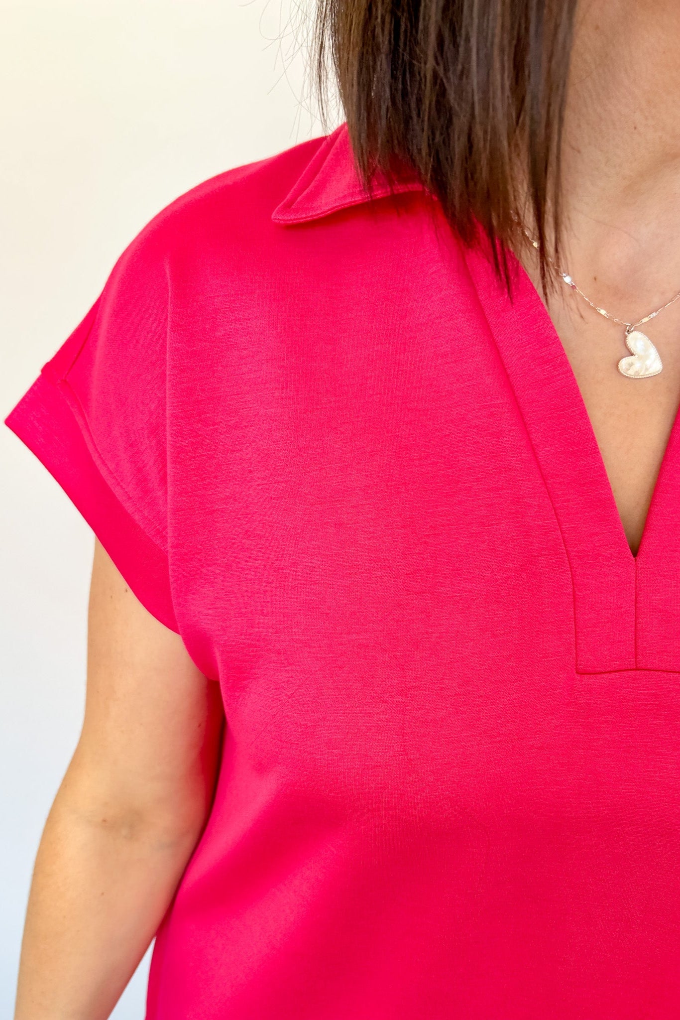 Athleisure dress that hits above the knees. Collared and short sleeve. Features a v neckline and pockets.  Fuchsia in color.