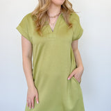 Athleisure dress that hits above the knees. Collared and short sleeve. Features a v neckline and pockets.  Kiwi in color.
