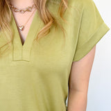 Athleisure dress that hits above the knees. Collared and short sleeve. Features a v neckline and pockets.  Kiwi in color.