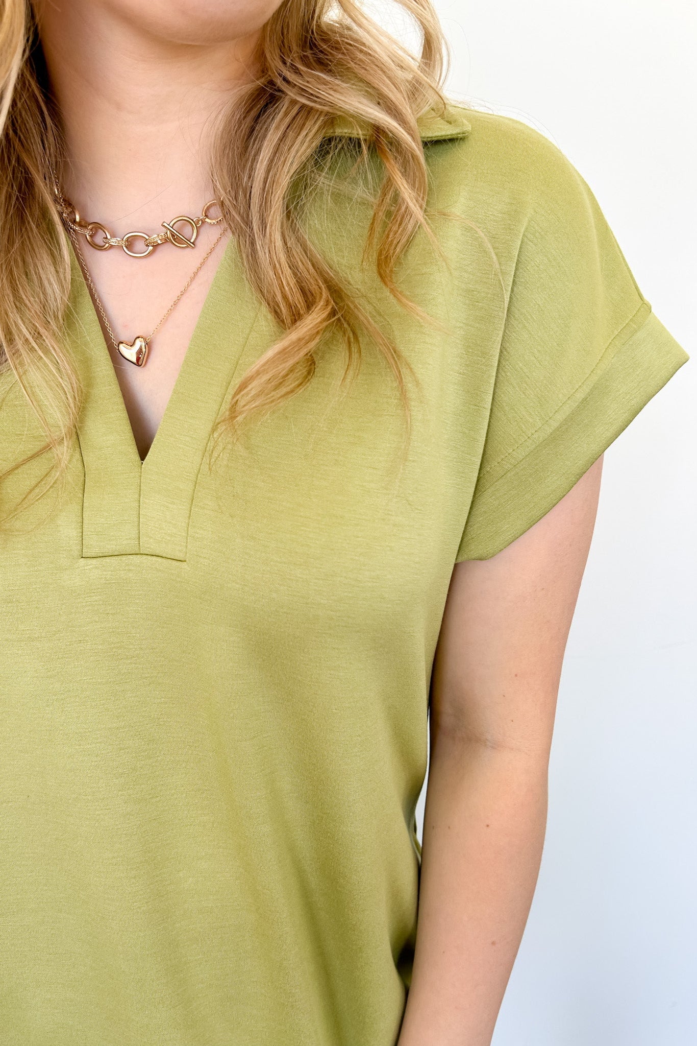 Athleisure dress that hits above the knees. Collared and short sleeve. Features a v neckline and pockets.  Kiwi in color.