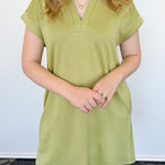 Athleisure dress that hits above the knees. Collared and short sleeve. Features a v neckline and pockets.  Kiwi in color.