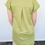 Athleisure dress that hits above the knees. Collared and short sleeve. Features a v neckline and pockets.  Kiwi in color.