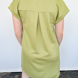 Athleisure dress that hits above the knees. Collared and short sleeve. Features a v neckline and pockets.  Kiwi in color.