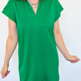 Athleisure dress that hits above the knees. Collared and short sleeve. Features a v neckline and pockets.  Emerald in color.