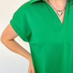 Athleisure dress that hits above the knees. Collared and short sleeve. Features a v neckline and pockets.  Emerald in color.