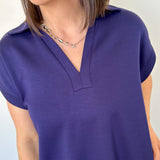 Athleisure dress that hits above the knees. Collared and short sleeve. Features a v neckline and pockets.  Navy in color.