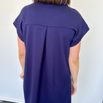 Athleisure dress that hits above the knees. Collared and short sleeve. Features a v neckline and pockets.  Navy in color.