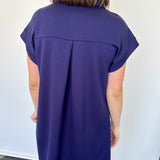Athleisure dress that hits above the knees. Collared and short sleeve. Features a v neckline and pockets.  Navy in color.