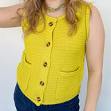 Button up vest with brown buttons. Pockets in the front. Braided detail around the tank sleeves and neckline, as well as the bottom of the top. Chartreuse in color.