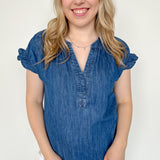 Denim top with slight v neckline and ruffled sleeves. Regular fit. Medium denim in color. Short sleeve. 