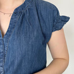 Denim top with slight v neckline and ruffled sleeves. Regular fit. Medium denim in color. Short sleeve. 