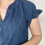 Denim top with slight v neckline and ruffled sleeves. Regular fit. Medium denim in color. Short sleeve. 
