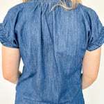 Denim top with slight v neckline and ruffled sleeves. Regular fit. Medium denim in color. Short sleeve. 