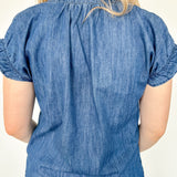 Denim top with slight v neckline and ruffled sleeves. Regular fit. Medium denim in color. Short sleeve. 