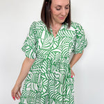 Green and white printed dress. Slight v neck. Short in length, hitting above the knee. Short sleeved.