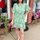 Green and white printed dress. Slight v neck. Short in length, hitting above the knee. Short sleeved.