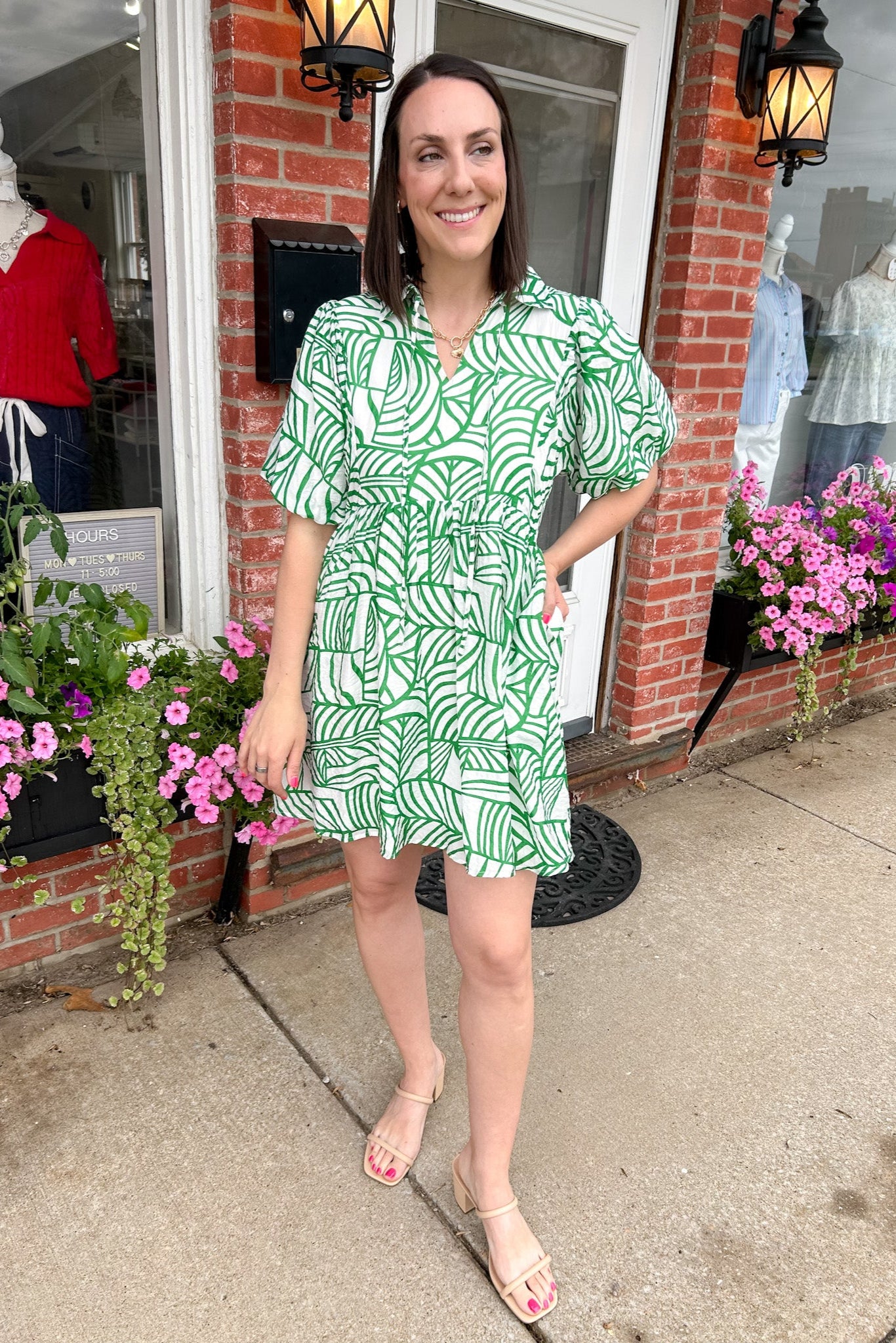 Green and white printed dress. Slight v neck. Short in length, hitting above the knee. Short sleeved.