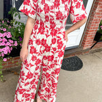 Red and white floral jumpsuit with square neckline. Short sleeved. Wide leg with smocked top. 