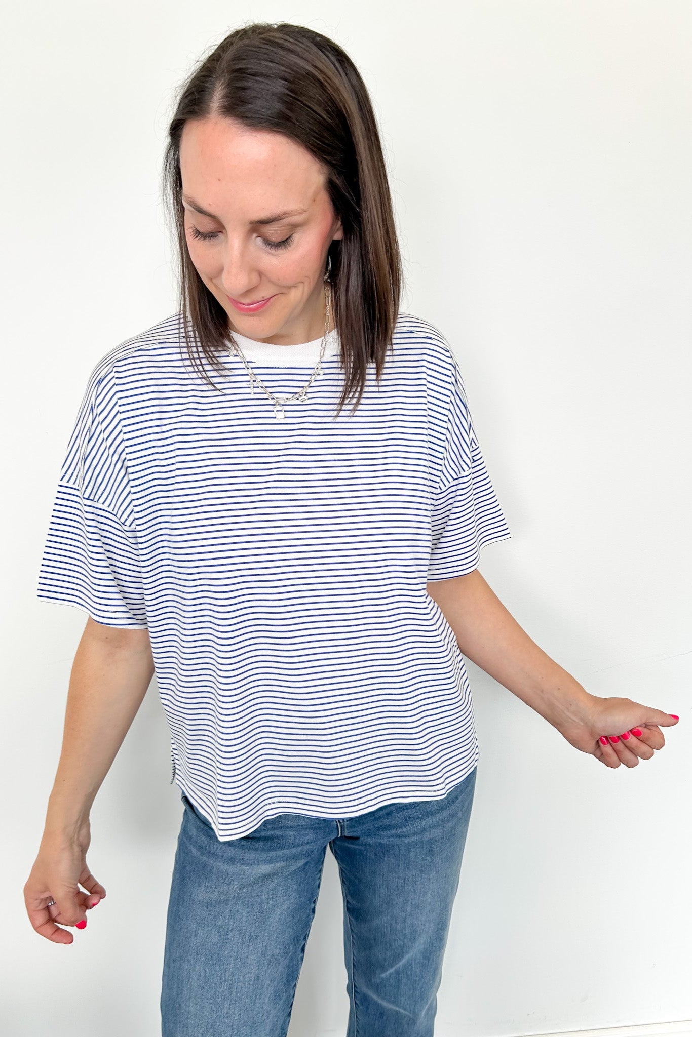 Oversized tee with crew neckline. White and royal blue in color. Striped pattern. 