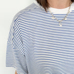 Oversized tee with crew neckline. White and royal blue in color. Striped pattern. 
