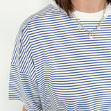 Oversized tee with crew neckline. White and royal blue in color. Striped pattern. 