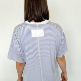 Oversized tee with crew neckline. White and royal blue in color. Striped pattern. 