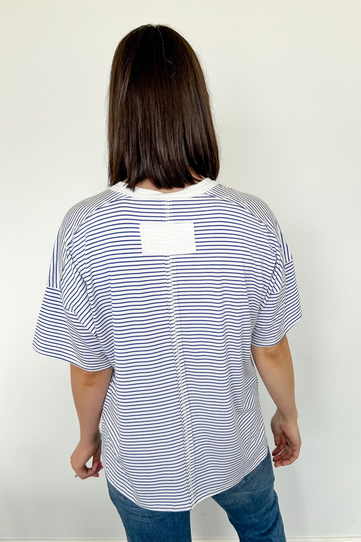 Oversized tee with crew neckline. White and royal blue in color. Striped pattern. 