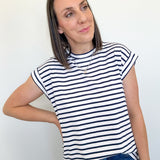 Woman wearing a black and white striped shirt against a plain background
