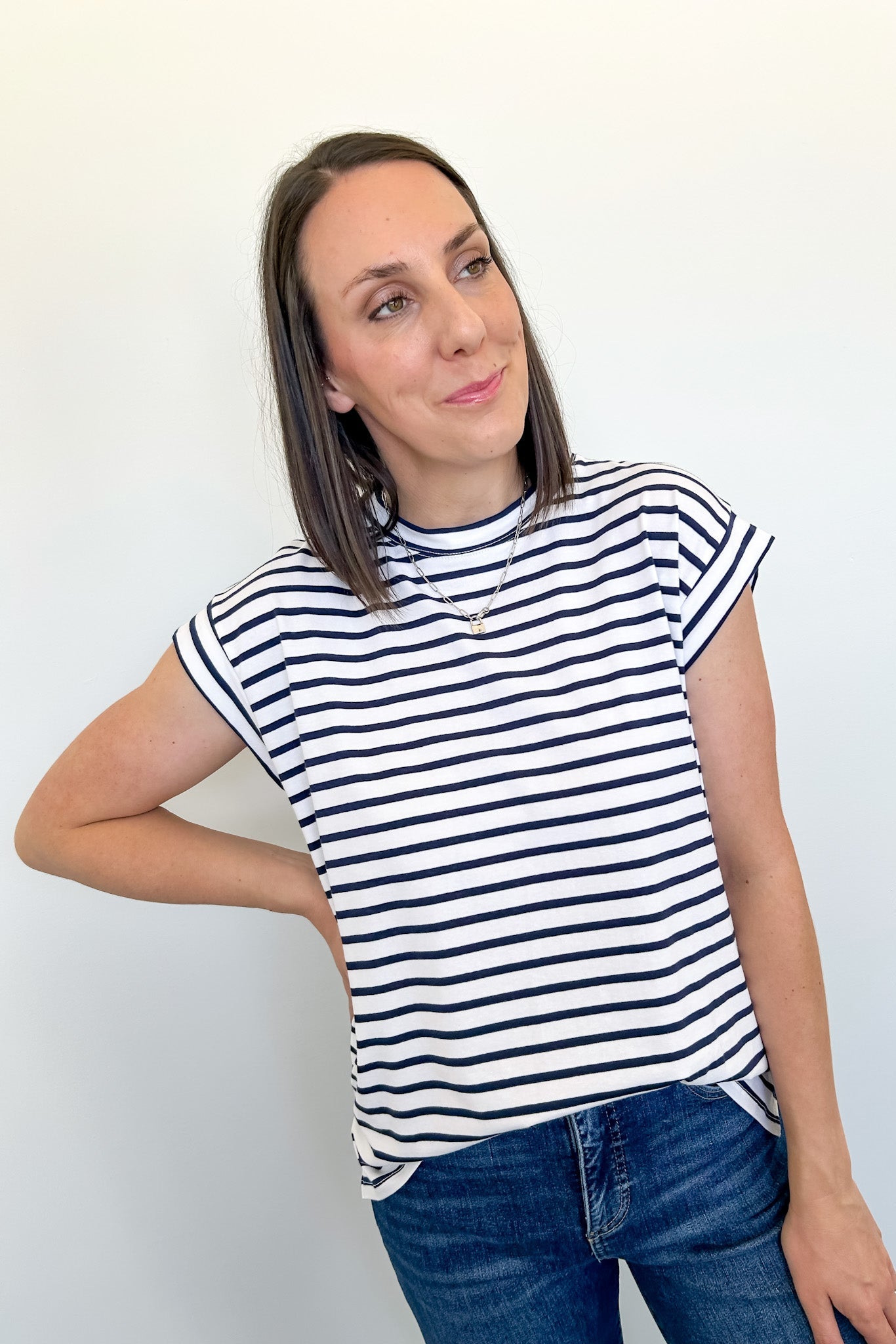 Woman wearing a black and white striped shirt against a plain background