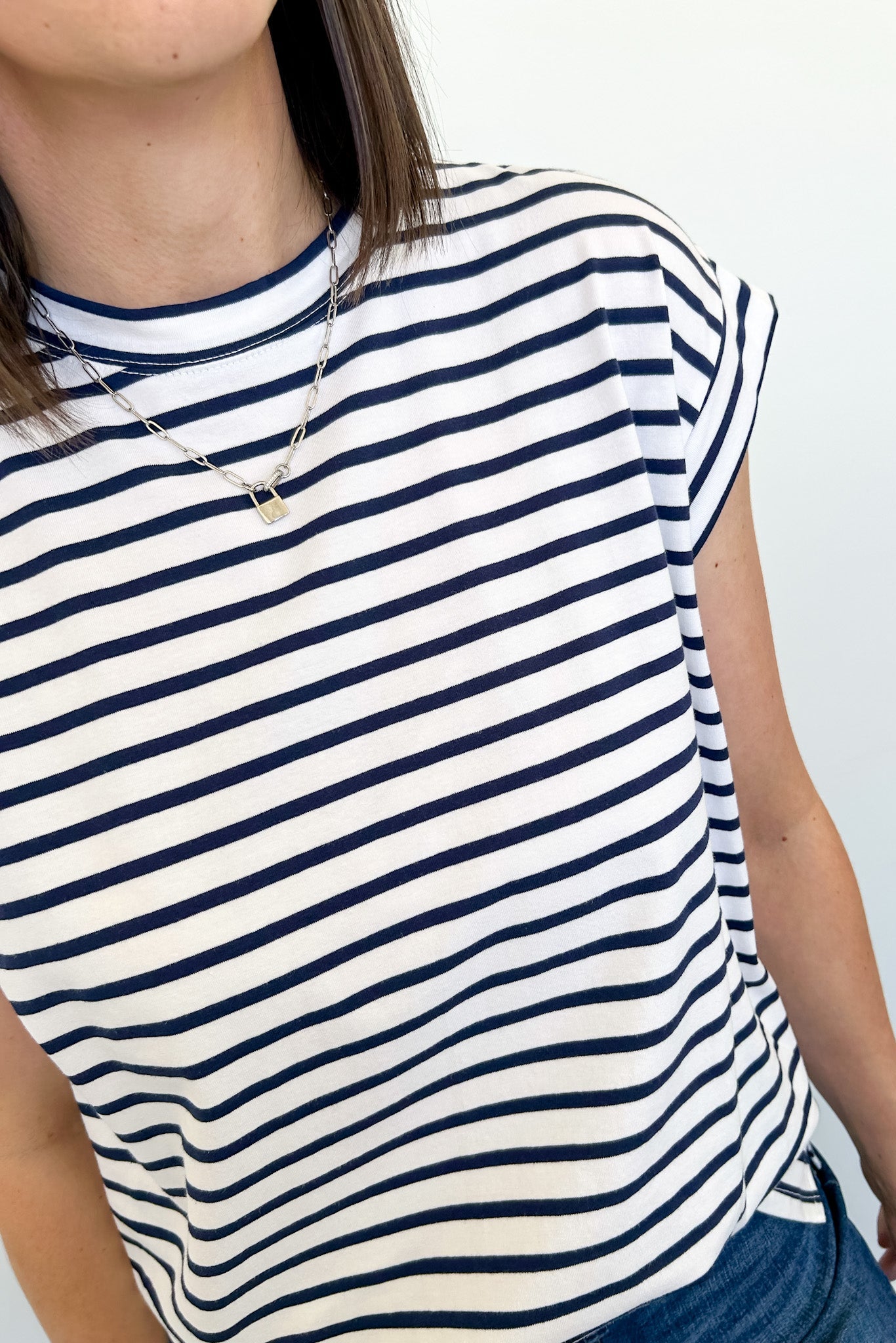 Person wearing a navy and white striped shirt against a plain background