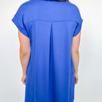 Person wearing a blue dress against a white background