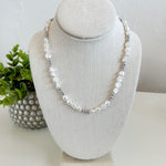 Pearl necklace on a white bust with a white background