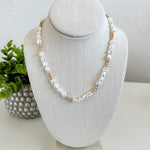 Pearl necklace on a gray bust with a white background