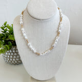 Pearl necklace on a gray bust with a white background