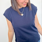 Woman wearing a blue t-shirt and jeans against a white background