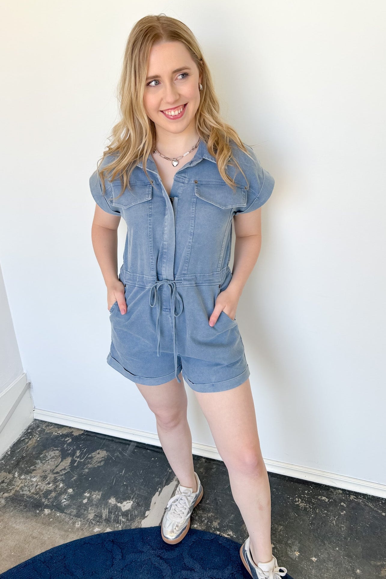 Photo of model wear a denim shorts romper with waist tie 