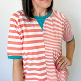 Photo of model wearing a peach and white striped shirt with half length sleeves
